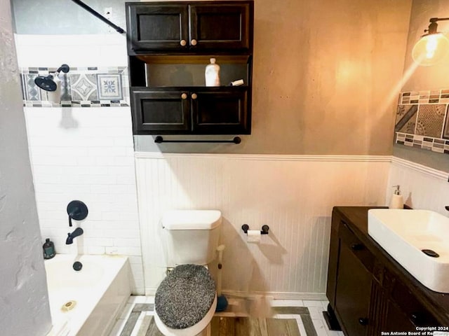 full bathroom featuring washtub / shower combination, vanity, and toilet