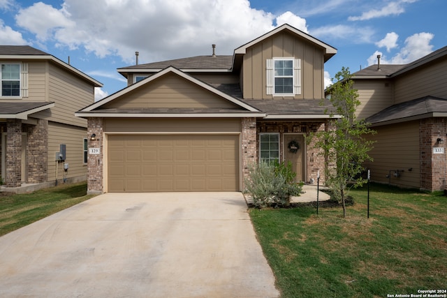 craftsman-style home with a garage and a front lawn