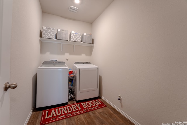 clothes washing area with independent washer and dryer and wood-type flooring