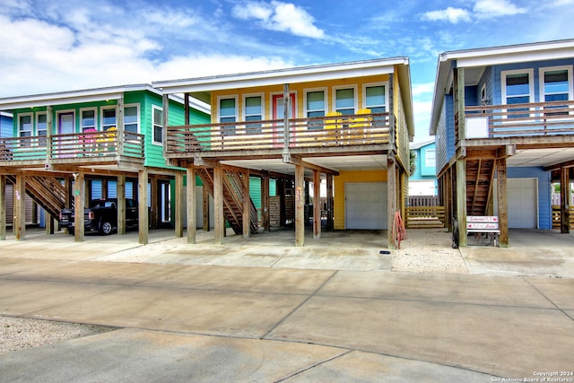 coastal inspired home with a carport and a garage