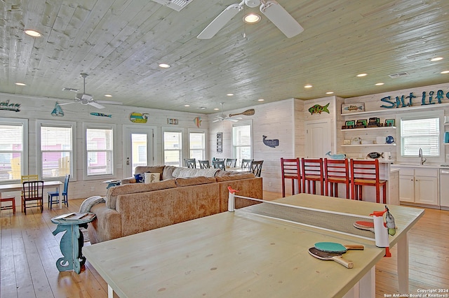 dining room with built in features, sink, light wood-type flooring, and ceiling fan