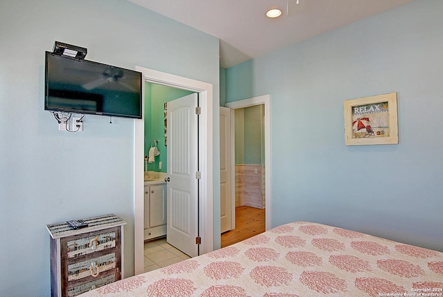 tiled bedroom featuring ensuite bath