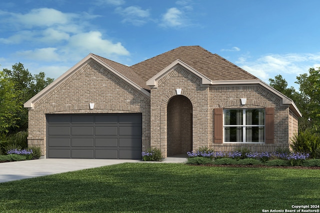 view of front of property featuring a garage and a front yard