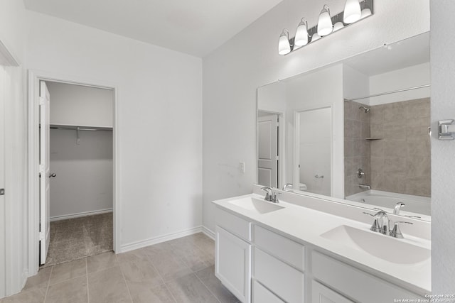 full bathroom featuring tiled shower / bath, vanity, tile patterned floors, and toilet