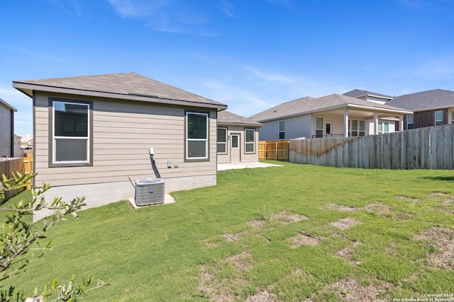 back of property featuring a yard and central AC unit