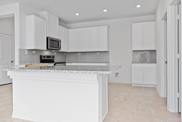 kitchen featuring appliances with stainless steel finishes, a center island, and white cabinets