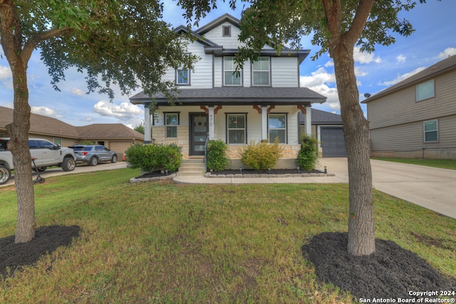 view of front facade featuring a garage, a porch, and a front yard