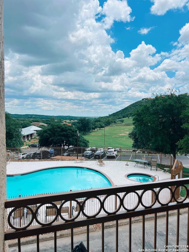 view of pool with a mountain view and a patio