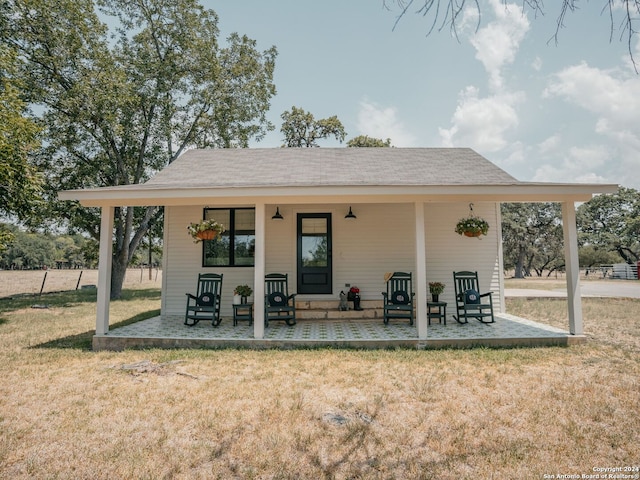 back of property with a yard, ceiling fan, and a patio area