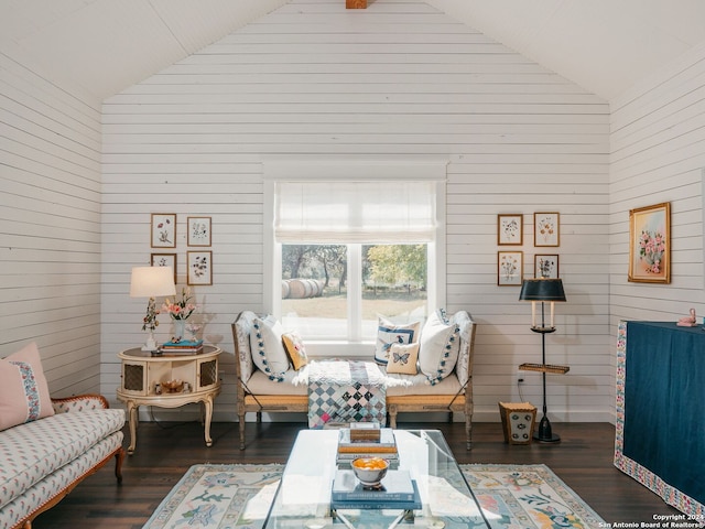 living room with wooden walls, dark hardwood / wood-style flooring, and high vaulted ceiling