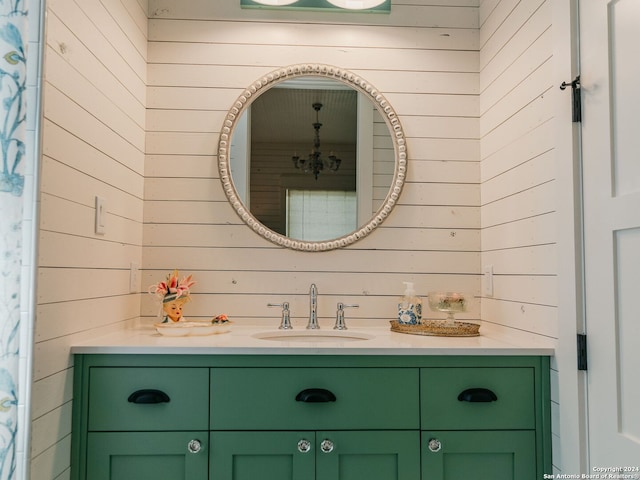 bathroom featuring vanity and wooden walls