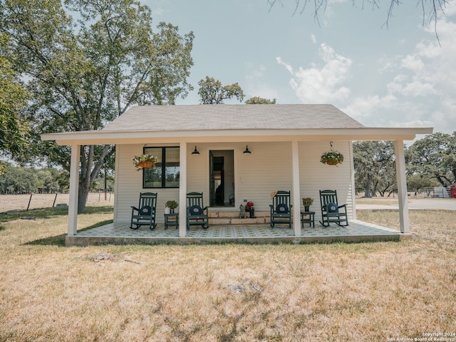 back of property with a yard and a patio area