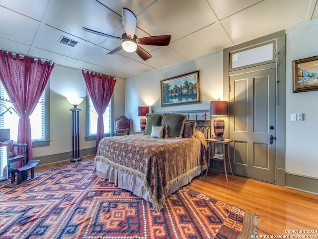 bedroom with ceiling fan and hardwood / wood-style flooring