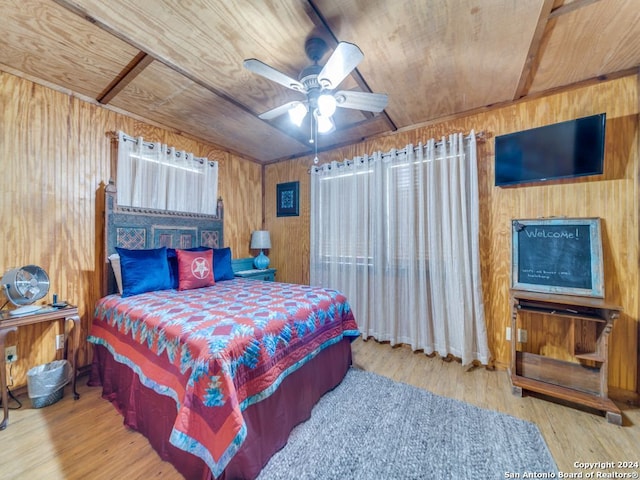 bedroom with ceiling fan, wooden ceiling, wood walls, and hardwood / wood-style flooring