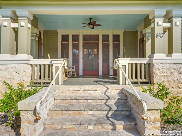 entrance to property featuring ceiling fan and a porch