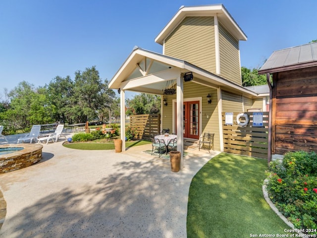 view of front facade with a patio and a jacuzzi