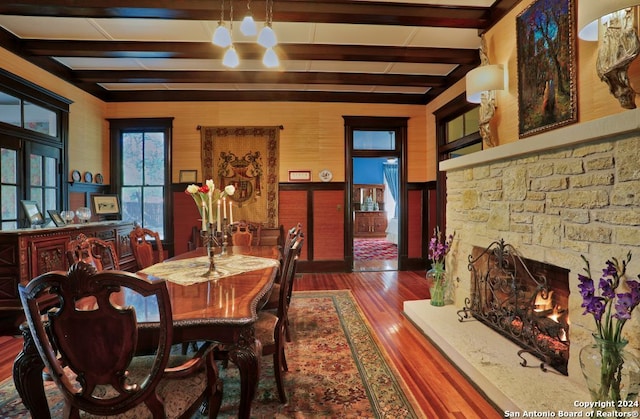 dining area with dark hardwood / wood-style flooring and beamed ceiling