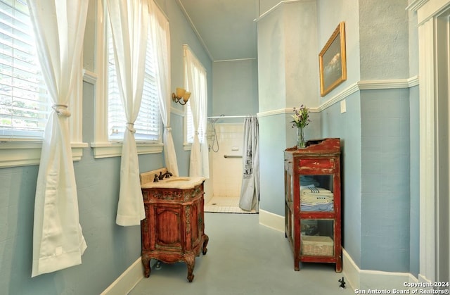 bathroom featuring a shower and concrete flooring