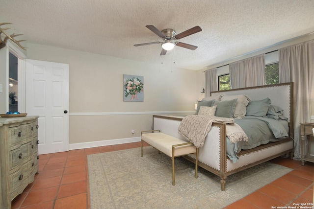 tiled bedroom featuring a textured ceiling and ceiling fan