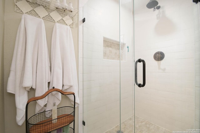 bathroom featuring a shower with shower door