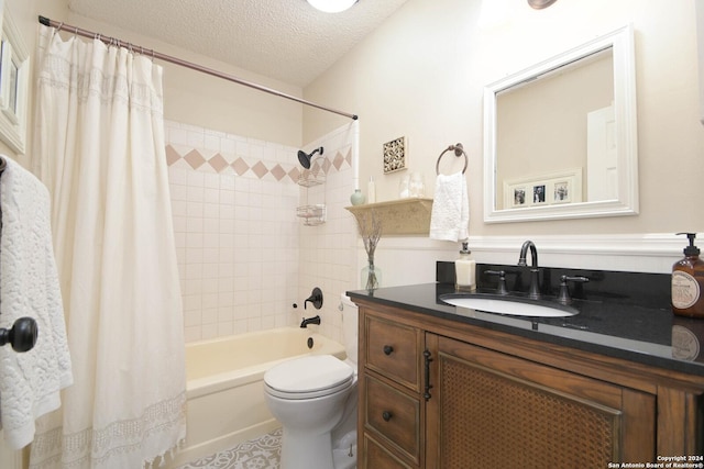 full bathroom featuring shower / bath combination with curtain, vanity, toilet, and a textured ceiling