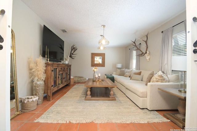 living room with tile patterned flooring and a textured ceiling