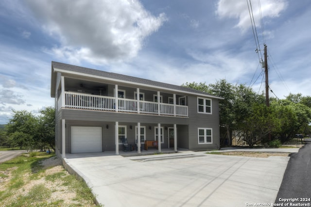 view of front of property featuring a garage and a balcony