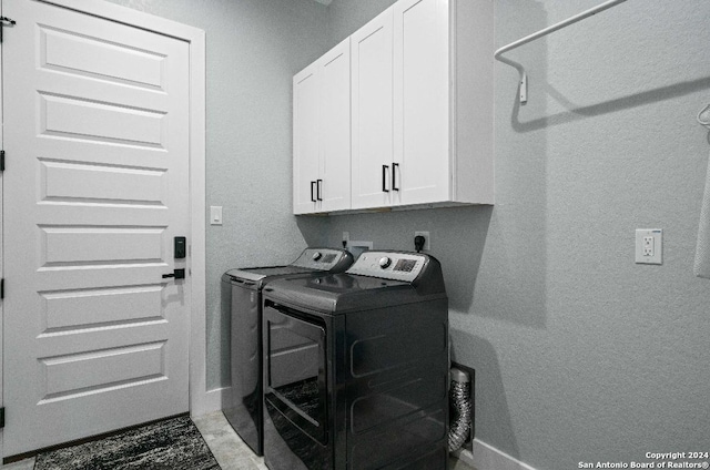 washroom with cabinets and independent washer and dryer