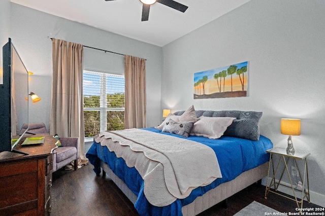 bedroom with ceiling fan and dark wood-type flooring