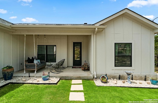 rear view of house with a yard and a patio