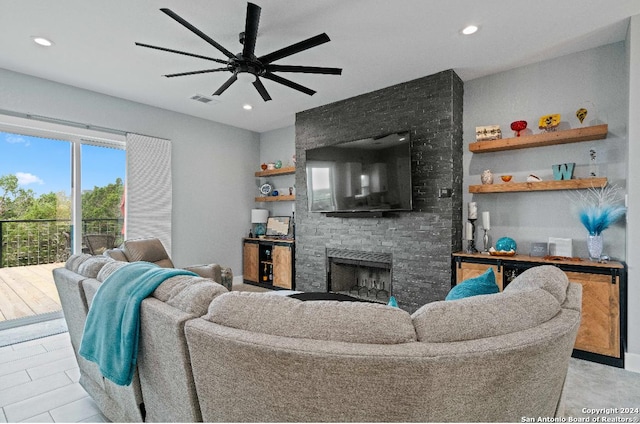 living room featuring a fireplace and ceiling fan