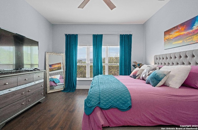 bedroom with dark hardwood / wood-style floors and ceiling fan