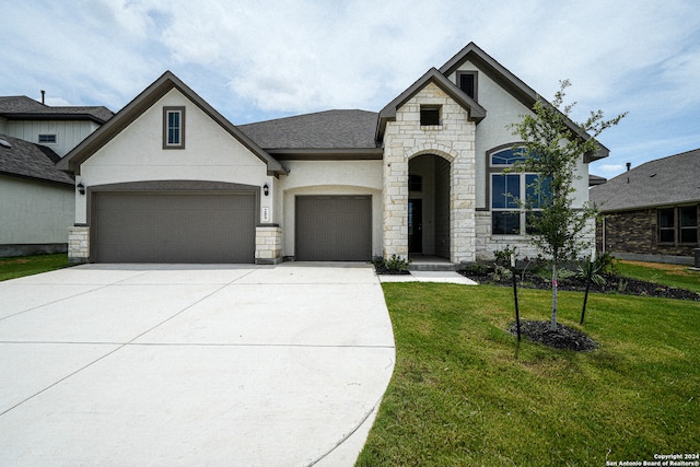 french country style house with a garage and a front yard