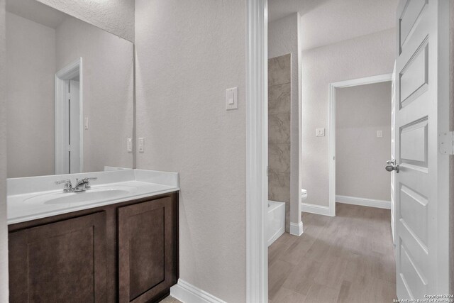 209 Canton Chase, Cibolo, TX 78108 - bathroom featuring toilet, vanity, a tub, baseboards, and a textured wall