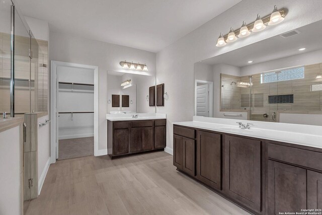 209 Canton Chase, Cibolo, TX 78108 - full bath with a shower stall, two vanities, wood finished floors, baseboards, and a walk in closet