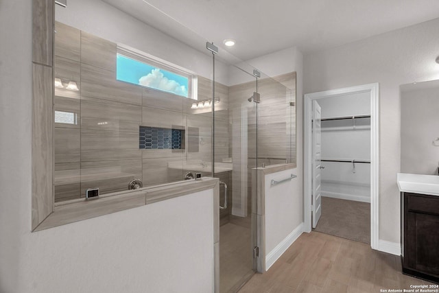209 Canton Chase, Cibolo, TX 78108 - bathroom featuring a stall shower, wood finished floors, a spacious closet, vanity, and baseboards