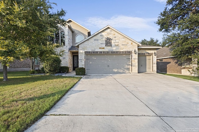 view of front facade with a garage and a front lawn