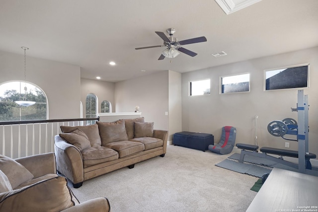 carpeted living room featuring ceiling fan