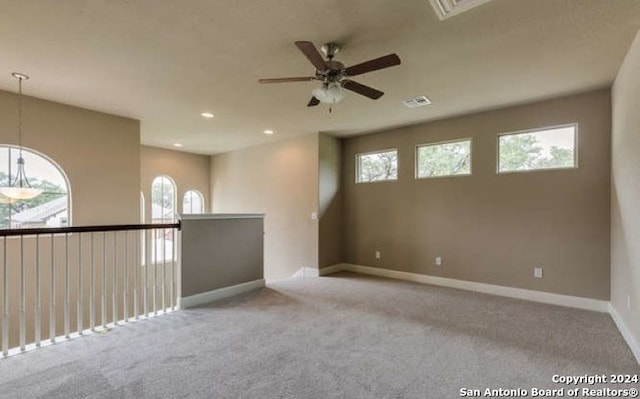 unfurnished room featuring ceiling fan and light carpet