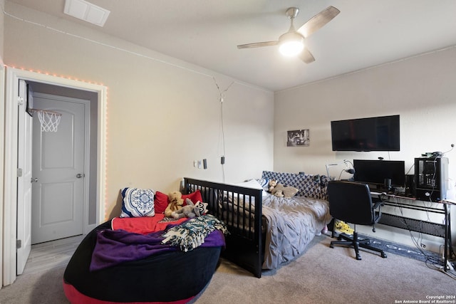 bedroom featuring ceiling fan and light colored carpet