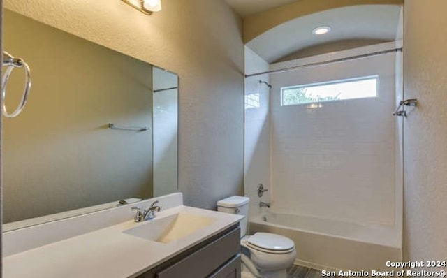 full bathroom featuring vanity, bathing tub / shower combination, and toilet