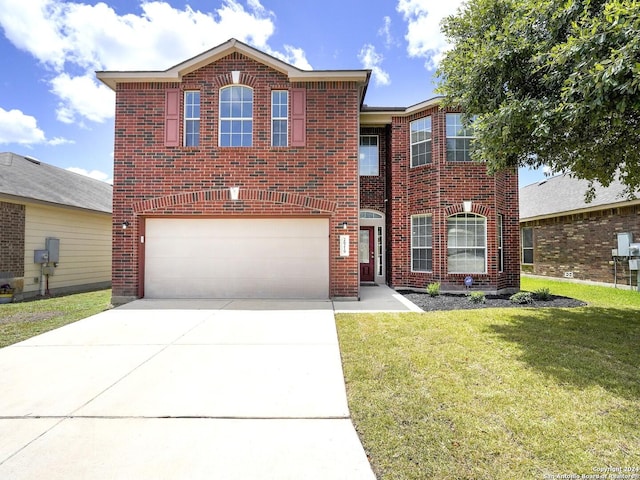 view of front of property featuring a garage and a front lawn