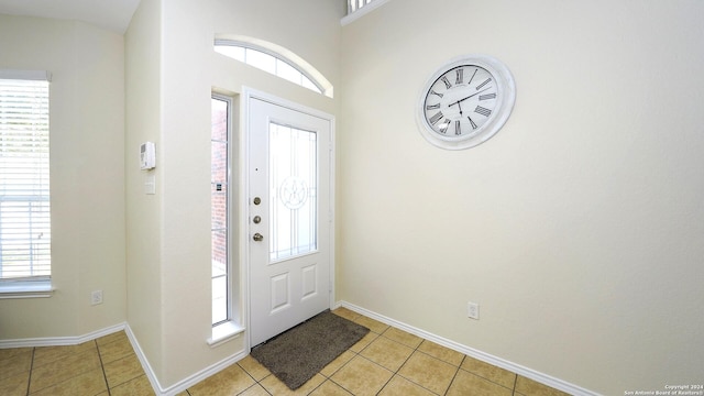 foyer entrance featuring a healthy amount of sunlight and light tile patterned floors