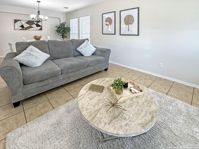 living room with tile patterned floors and a notable chandelier