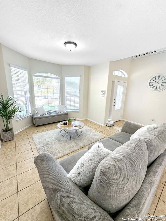 living room with light tile patterned floors and a textured ceiling