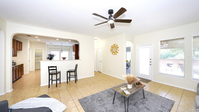 tiled living room with ceiling fan