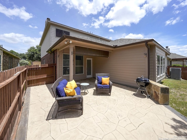 back of property with a patio area and central air condition unit