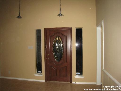 entrance foyer featuring a high ceiling and tile patterned floors