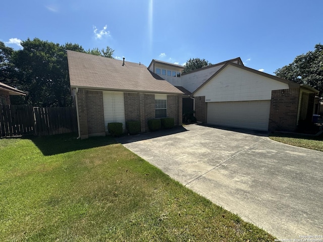 ranch-style house with a garage, a front yard, brick siding, and fence