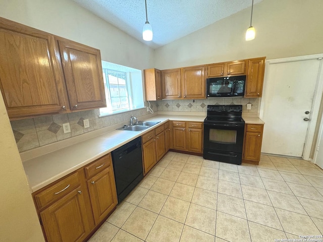 kitchen featuring a textured ceiling, vaulted ceiling, black appliances, pendant lighting, and sink